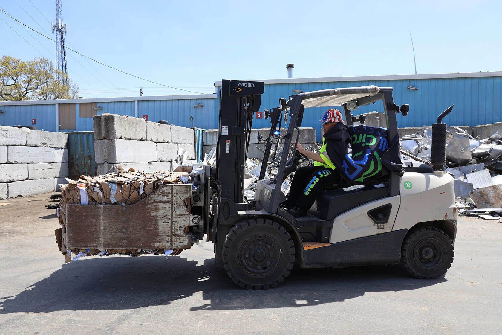 Team Member Moving Baled Cardboard